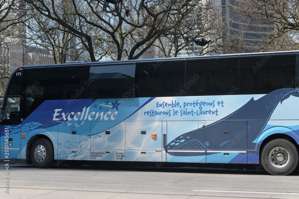 Naklejka premium exterior side view of Autocar Excellence / Excellence Charter, a Quebec‑based coach/charter company, parked on Queen St W, near City Hall, Toronto