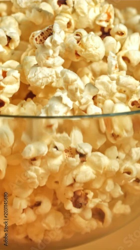 A bowl of popcorn falls on a yellow background. Filmed on a high-speed camera at 1000 fps. High quality FullHD footage