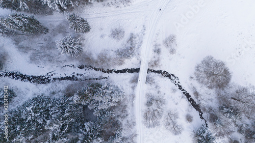 Schilderij op canvas Aerial top down view of a winter Carpathian river in the forest covered in snow