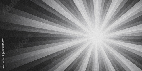 Foto Bright sunburst rays shining through dark clouds with dramatic contrast black an