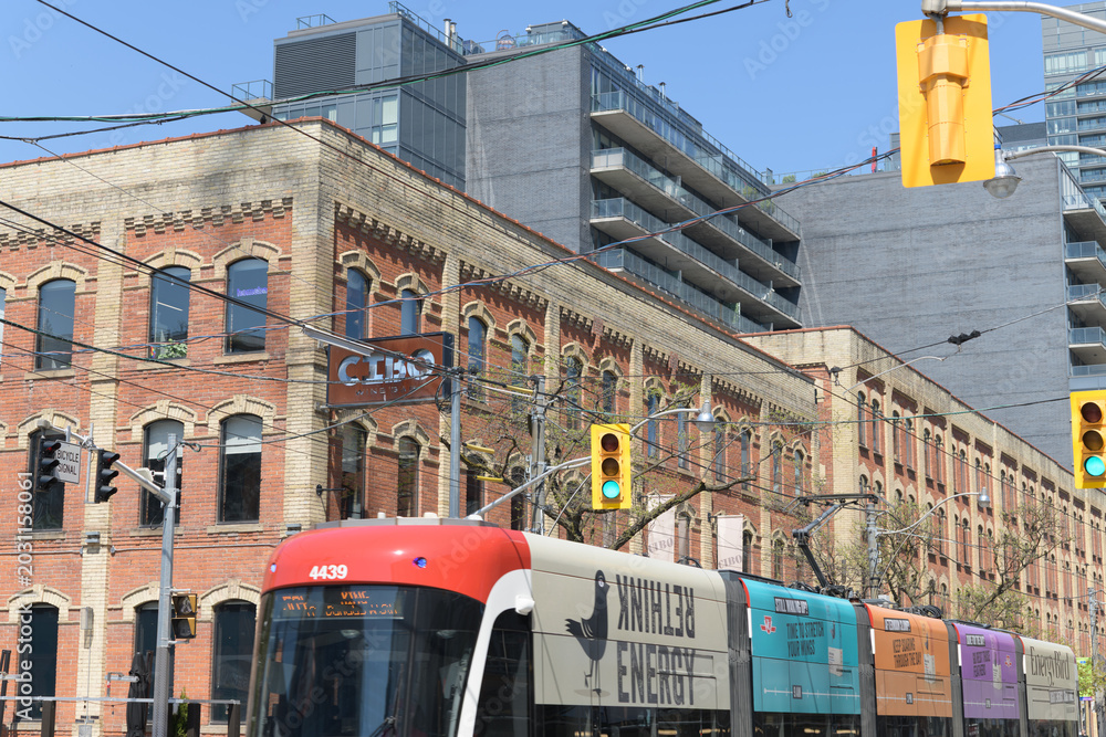 Naklejka premium trolley with advertising wrap for Energy Bird on King St W outside Cibo Wine Bar (historic E.C. Gurney & Co. Stove Foundry building, Toronto