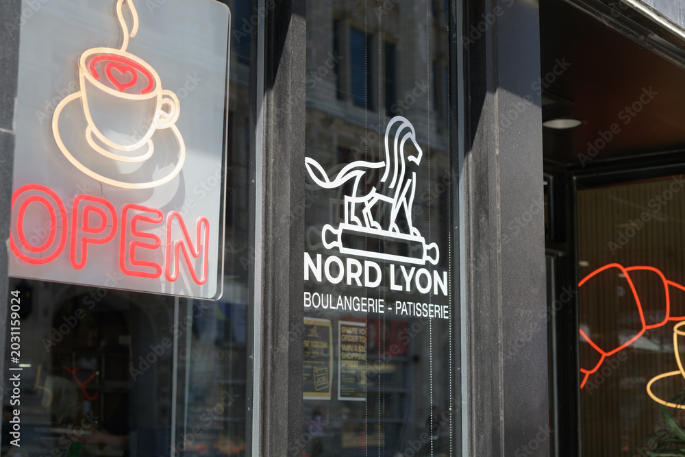 Naklejka premium window signs at Nord Lyon, a bakery, located here at 250 Queen St W, Toronto