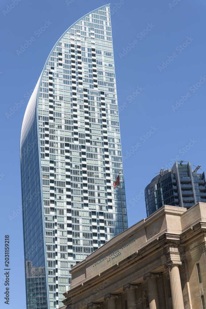 Naklejka premium dramatic, sculptural sweep of L-Tower's curved top profile designed by Daniel Libeskind at 8 The Esplanade (contrast with Dominion Public Building) Toronto