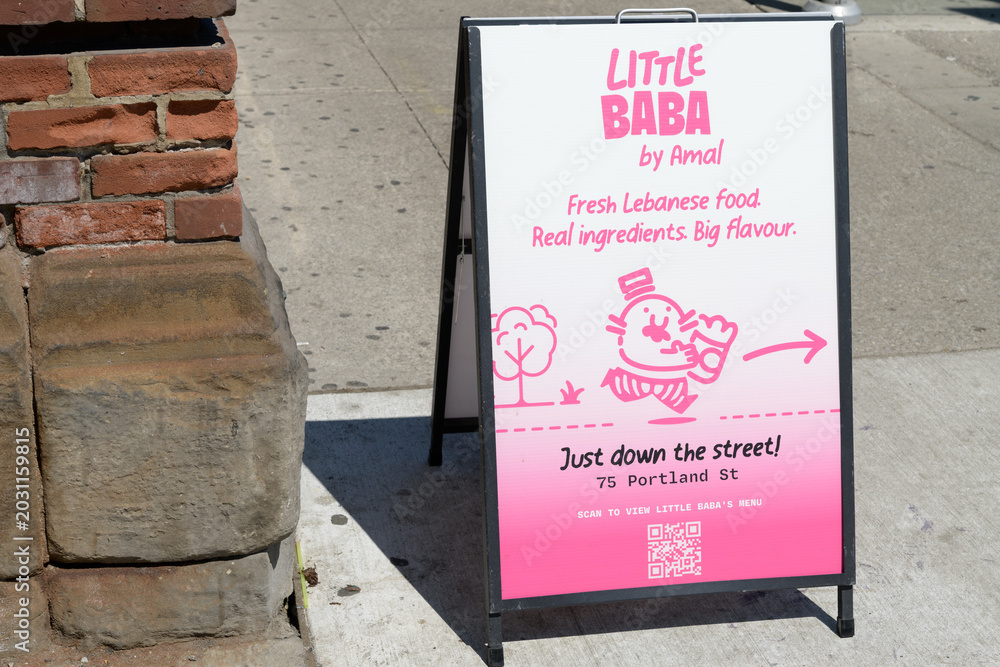 Naklejka premium A-Frame sidewalk sign of Little Baba, a fast food restaurant, near 75 Portland St, Toronto