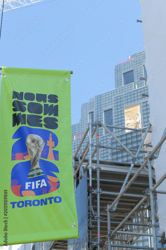 Naklejka premium pole mounted banner advertising for FIFA World Cup 2026 tourney in Toronto (behind) King Toronto Condos