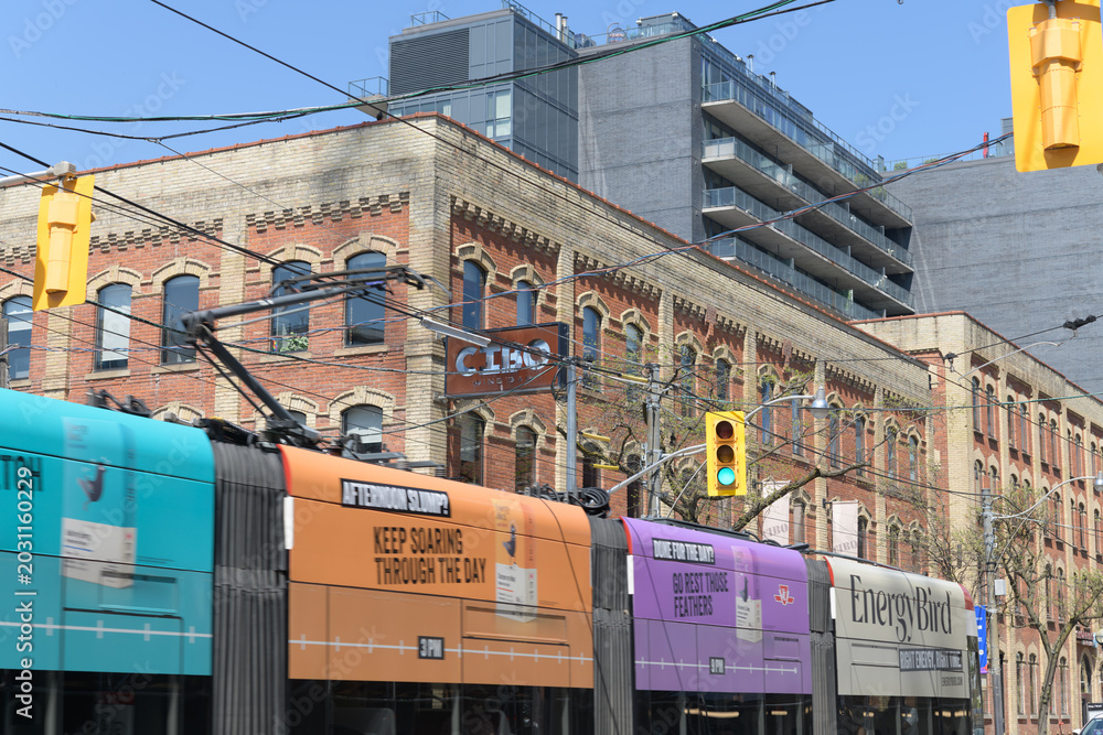 Naklejka premium trolley with advertising wrap for Energy Bird on King St W outside Cibo Wine Bar (historic E.C. Gurney & Co. Stove Foundry building, Toronto