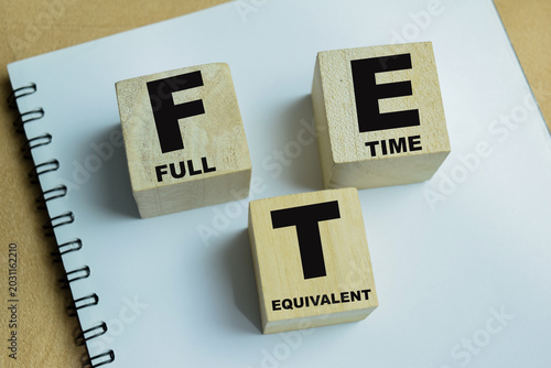Photos Concept of text FTE - Full Time Equivalent on wooden blocks.