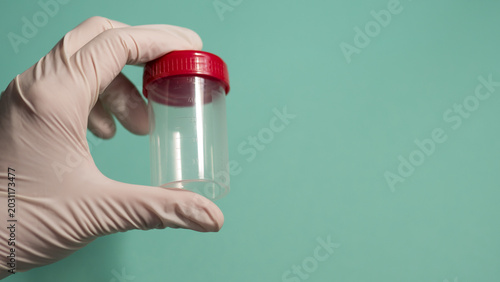 Photos Gloved Hand Holding Empty Specimen Container with Red Cap — Medical Sample Colle