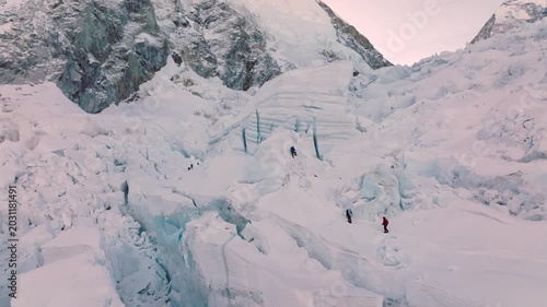 Alpinists and Sherpas climbing the Himalayan Khumbu icefall on the way to Mount Everest