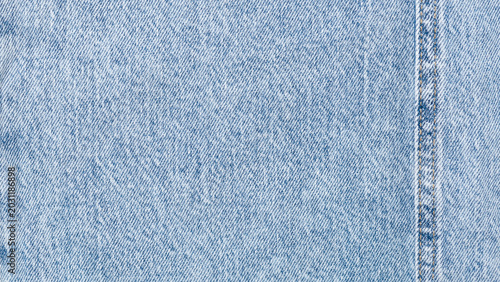 Fotografie Close up of light blue denim fabric texture with visible weave and soft washed e