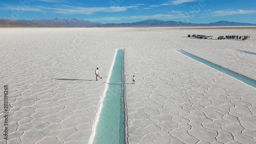 Принти на полотні Aerial view of father and child playing soccer onwhite salt flats Salinas Jujuy