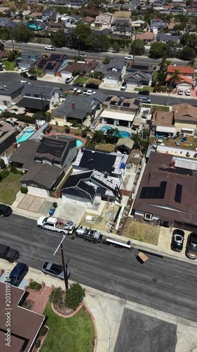 Drone footage of a residential street community with active home renovation and eco friendly upgrades 4k