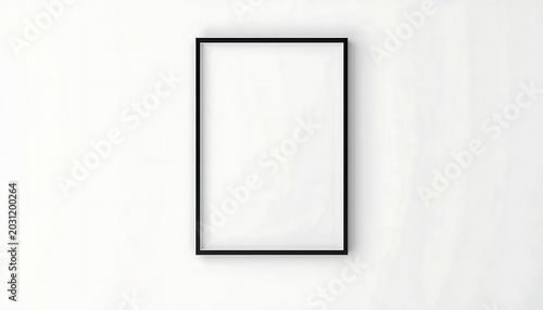 Frame with a thin black border hangs on a white wall providing space for artistic print placement.