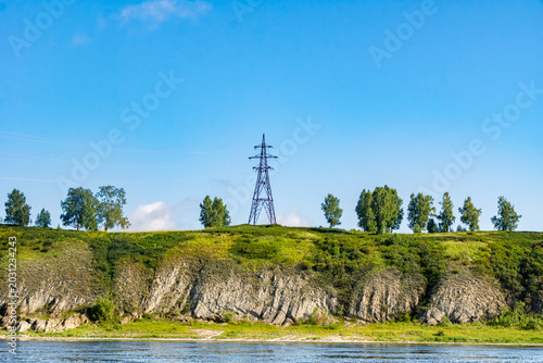Принти на полотні High voltage transmission tower VL-35kV to VL-100kV standing on rocky riverbank