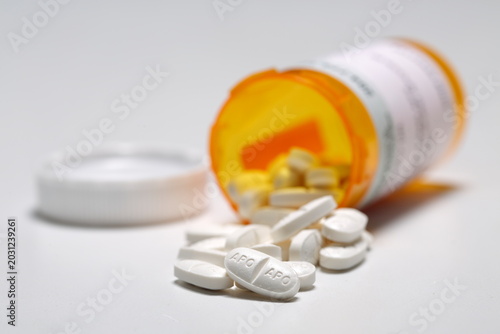 Medication diabetes gliclazide MR 60mg white oblong tablet,  prescription vial, white background close up