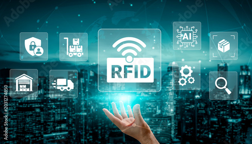 Tableau sur toile A hand reaches out towards holographic RFID technology icons in an urban landscape, symbolizing innovation in logistics, supply chain, and digital connectivity