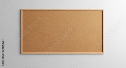 Blank Cork Bulletin Board with Wooden Frame on White Wall.