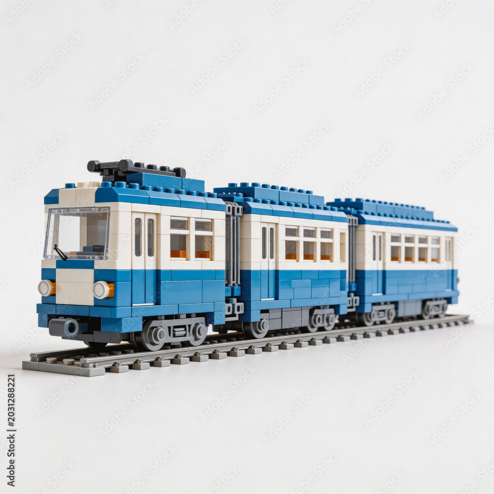 Obraz premium A detailed two-car tram model built from toy building bricks, placed on a standard railway track against a plain white background.