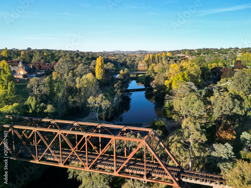 Historic Yass Railway Bridge spans a scenic river in autumn