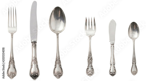 Elegant vintage silver flatware set: forks, knives, spoons in a row, ornate handles on transparent background.