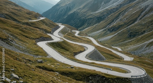 A winding road snakes through a mountain pass, amidst green slopes