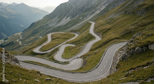 Winding road snakes through a mountain pass with lush green slopes
