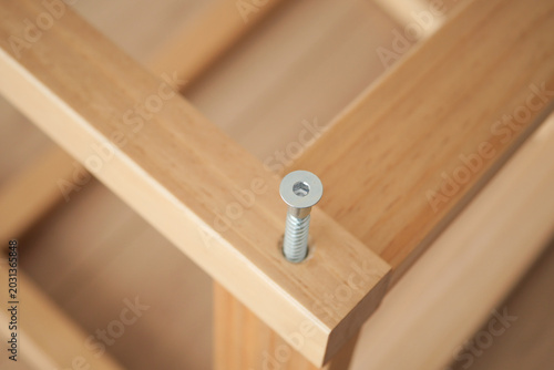Wood frame assembly with visible screw detail during work