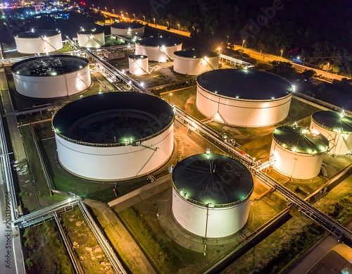 Aerial view of large industrial storage tanks at night