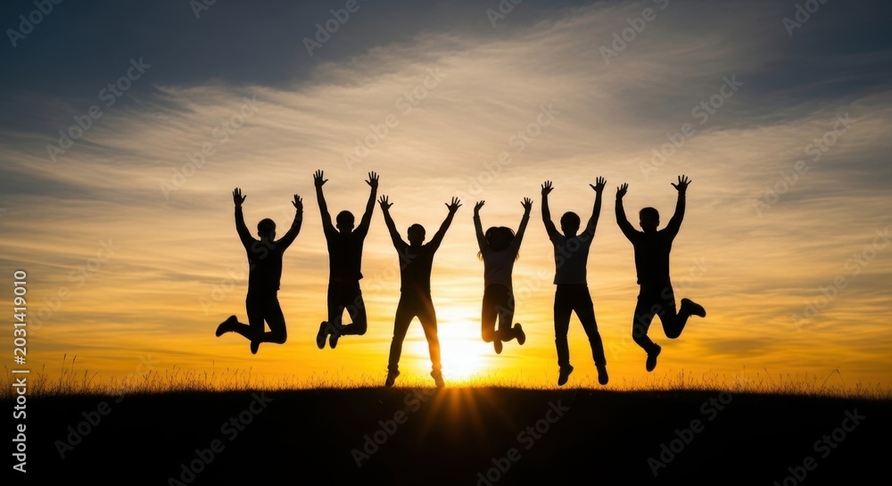 Fototapeta premium Joyful Silhouettes of Friends Jumping Together Against a Vibrant Sunset Sky