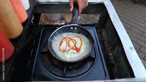 Frying Pan with Melted Butter on Portable Stove in Outdoor Kitchen