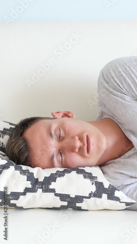 White Man Napping On Couch Pillow, Soft Daylight, Patterned Cushion, Gray Tshirt, Slow Breathing, Subtle Head Turn, Midday Pause After Long Workday, Tired Expression Melting Into Rest