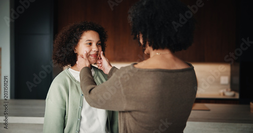 Tableau sur toile Mom, child and care with family in home, happy and touch face for admiration with mother and daughter love