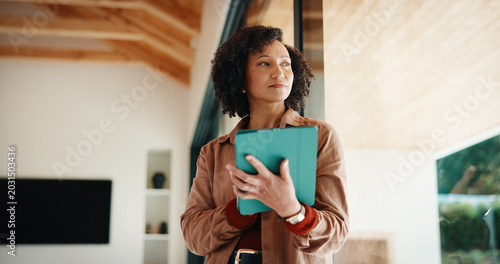 фотографія Thinking, woman and tablet in home for planning, real estate and property research for auction