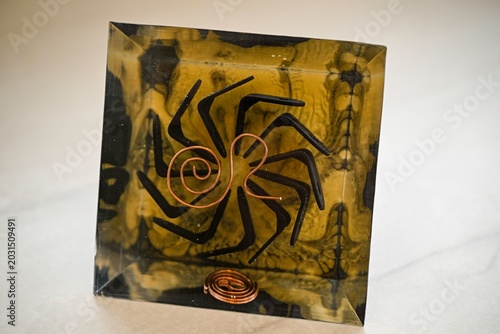 Handmade Orgone Pyramid with Pyrite Crystal and Obsidian Layers – Unique Black and Gold Energy Pyramid with Circular Metal Geometry, Close-Up Isolated on White Background
