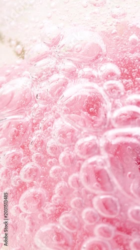 Vertical pink serum gel background, cream, shampoo, soap bubbles, foam texture