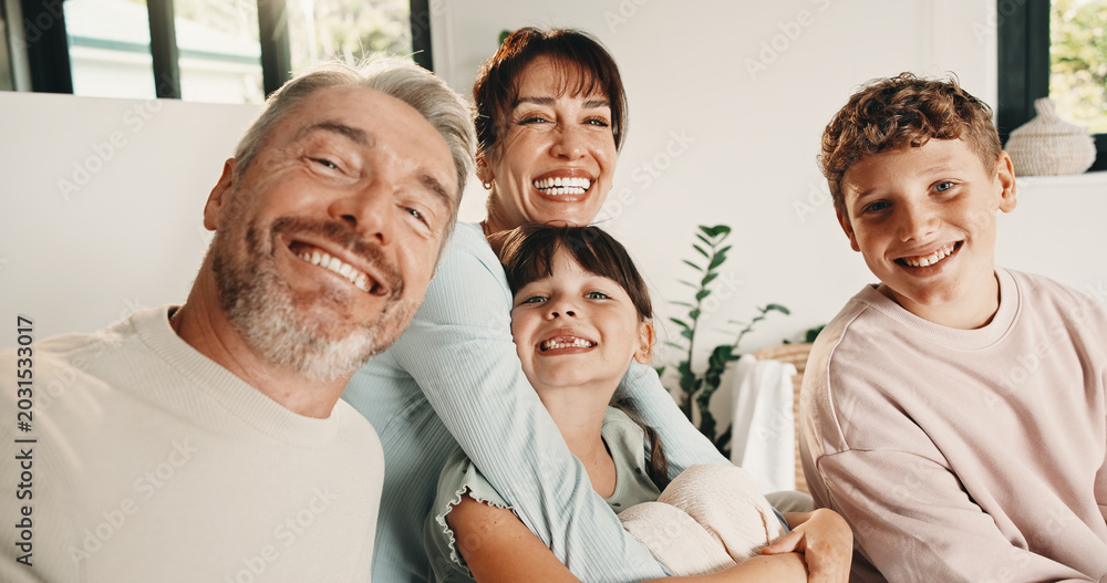 Obraz premium Selfie, portrait and family in home on sofa for memory, bonding or social media post together. Smile, photography and parents with children for profile picture in living room of house for weekend