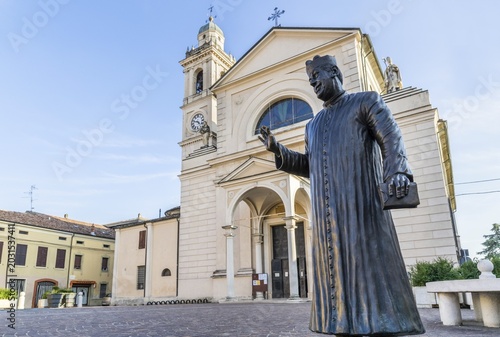 Statue of Don Camillo in Piazza Giacomo Matteotti in front of the Church of Santa Maria Nascente, location of the films of Don Camillo and Peppone, Brescello, Province of Reggio Emilia, Emilia-Romagna, Italy