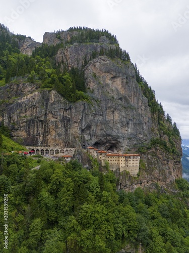 A monastery perched monumentally on a steep rock face, surrounded by dense forests, aerial view, Sumela Monastery, Sümela Manastırı, Maçka, Macka, Trabzon Province, Turkey