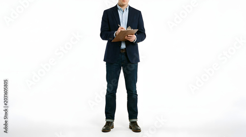 Man in navy blazer writing on clipboard with white background, smart casual