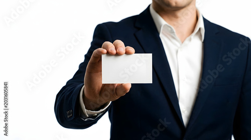 Man in suit holding out blank business card with white background, isolated