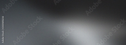 Abstract gray grain background with soft white light and subtle noise texture, creating a smooth and atmospheric monochrome gradient.