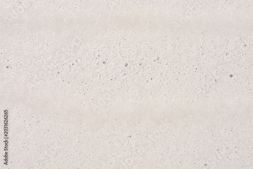 Photos A close up shot captures a dense white foam surface filled with countless tiny uniform bubbles creating a soft abstract pattern