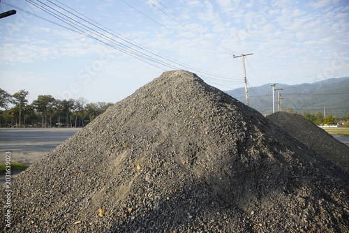 Gravel Heap with Mountains and Blue Sky