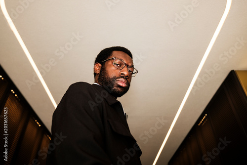 Photos Black man looking directly at the camera with glasses