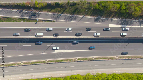 фотографія TOP DOWN: Flying above countless vehicles moving through a congestion on highway