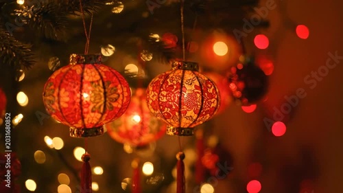 Red Chinese Lanterns Hanging on Christmas Tree.