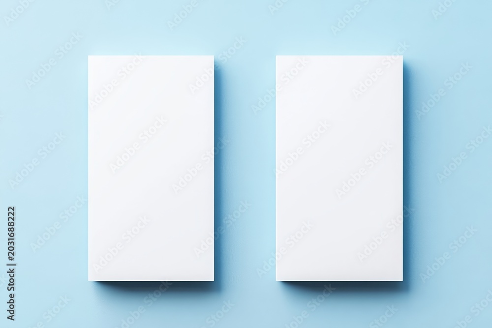 Fototapeta premium Two vertical blank white rectangular panels positioned side by side with soft shadows on a light blue background creating a clean minimal presentation mockup