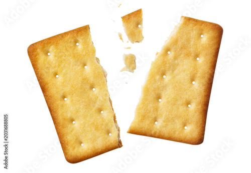 Cracked crispy biscuit split into parts with crumbs, isolated on cutout transparent background