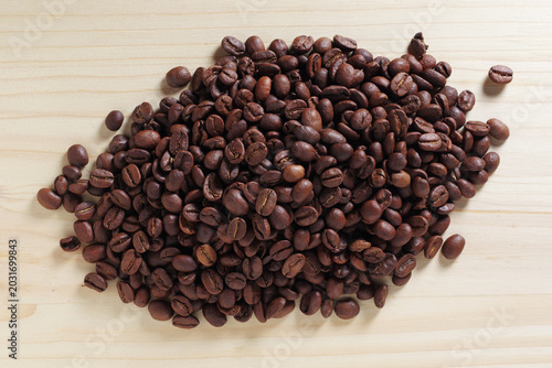 Roasted coffee beans on wooden background