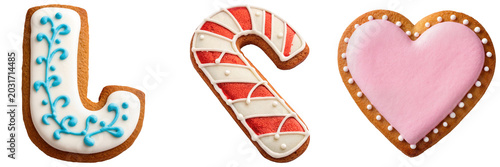 Cuadro en lienzo Three decorated gingerbread cookies: letter L, candy cane, and heart shape, isol